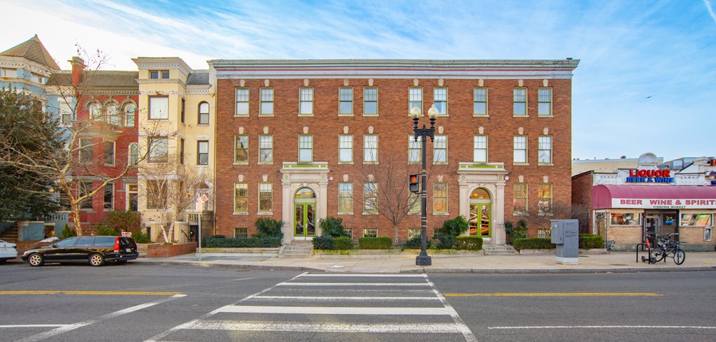 a red brick building on the corner of a city street