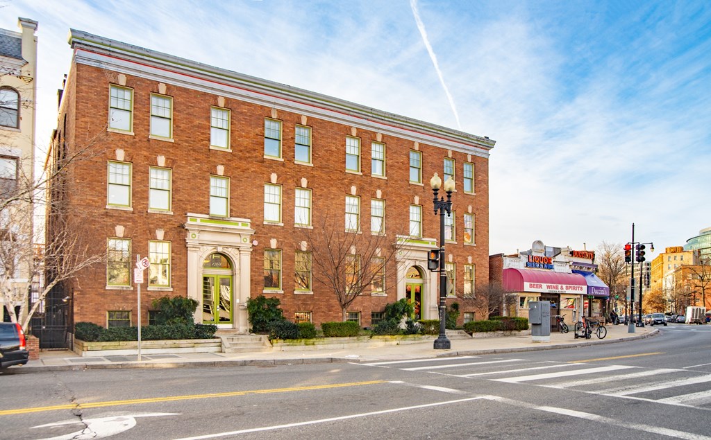 a large brick building on the corner of a city street