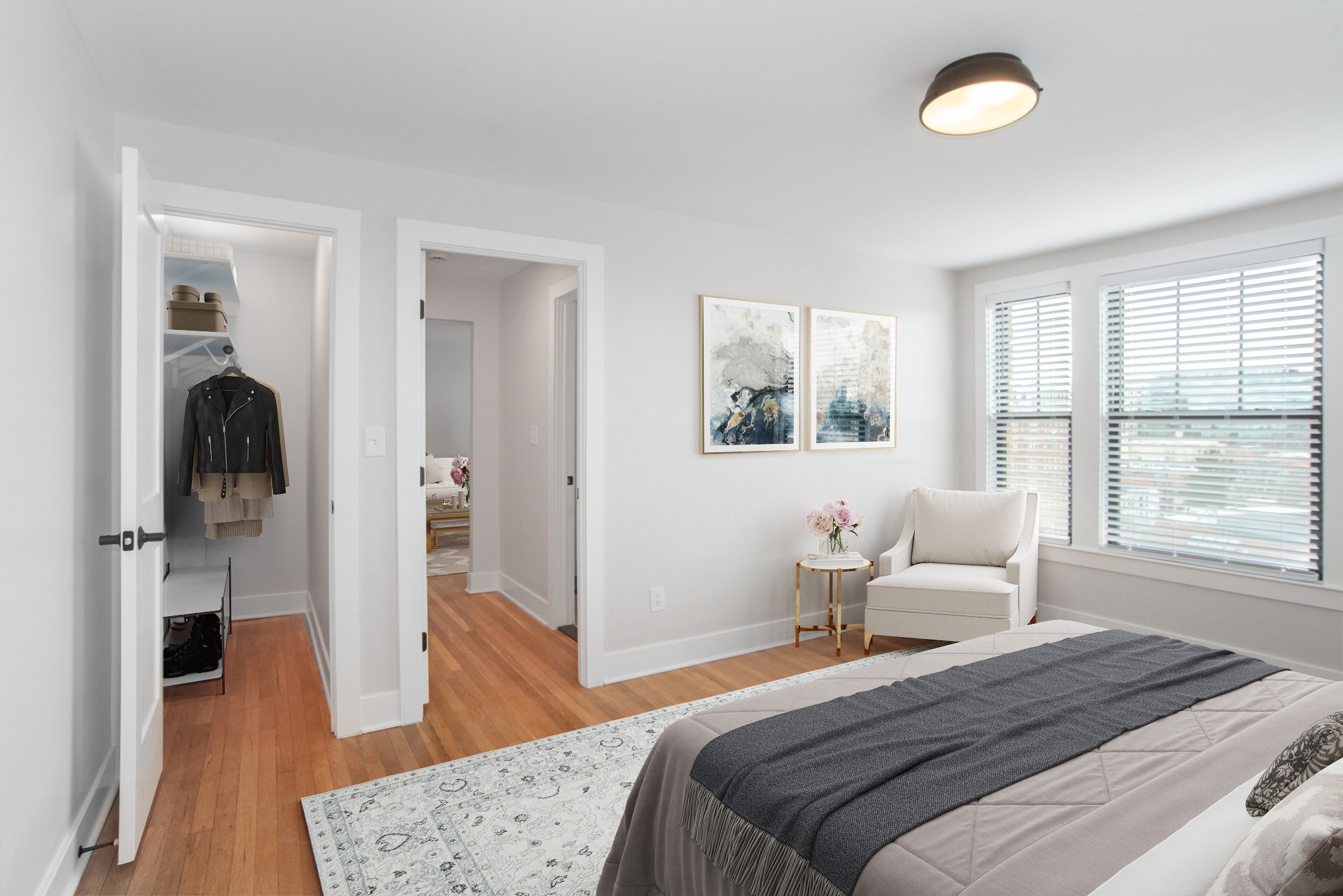 A bedroom with a large bed and a painting on the wall.