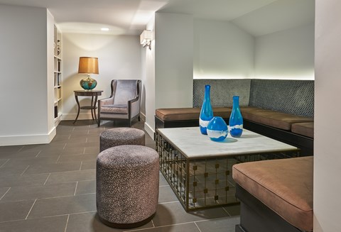 a living room with couches and a table with vases