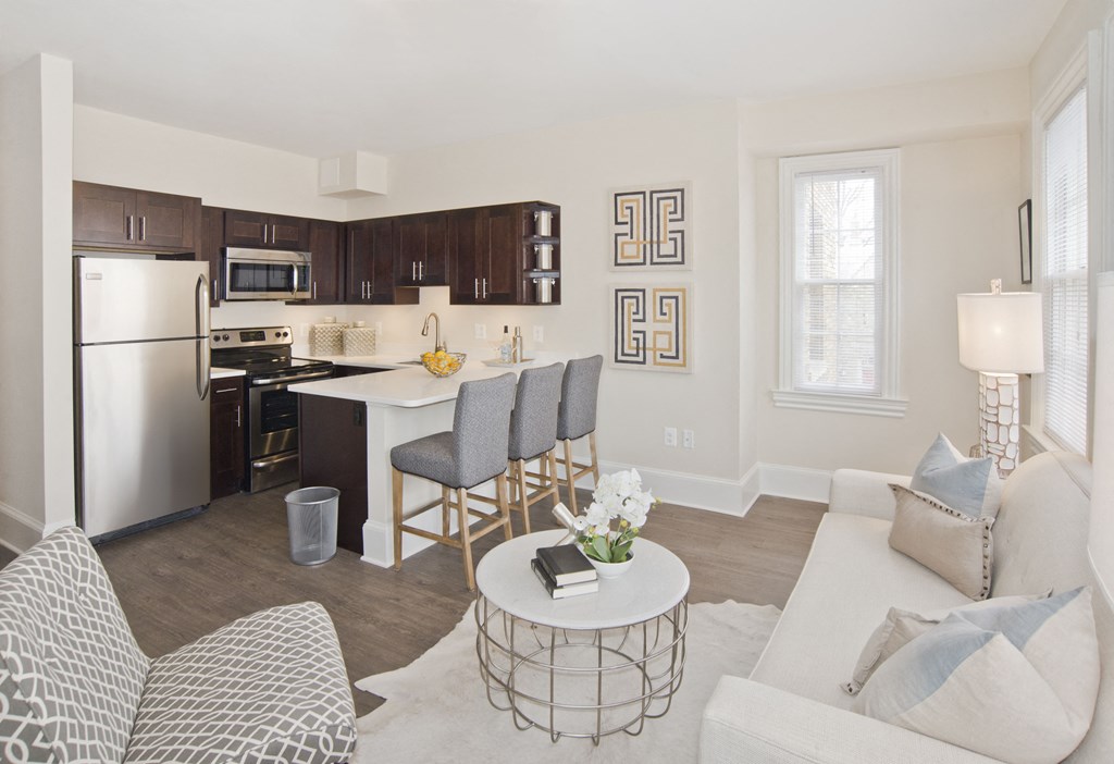 a living room and kitchen with a white couch and a table