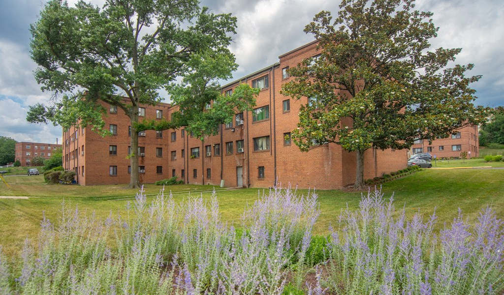 a brick building with trees in front of it