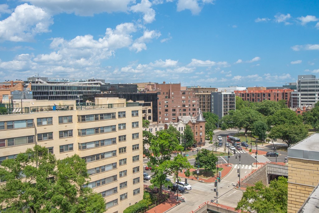 an aerial view of a city street with buildings and trees