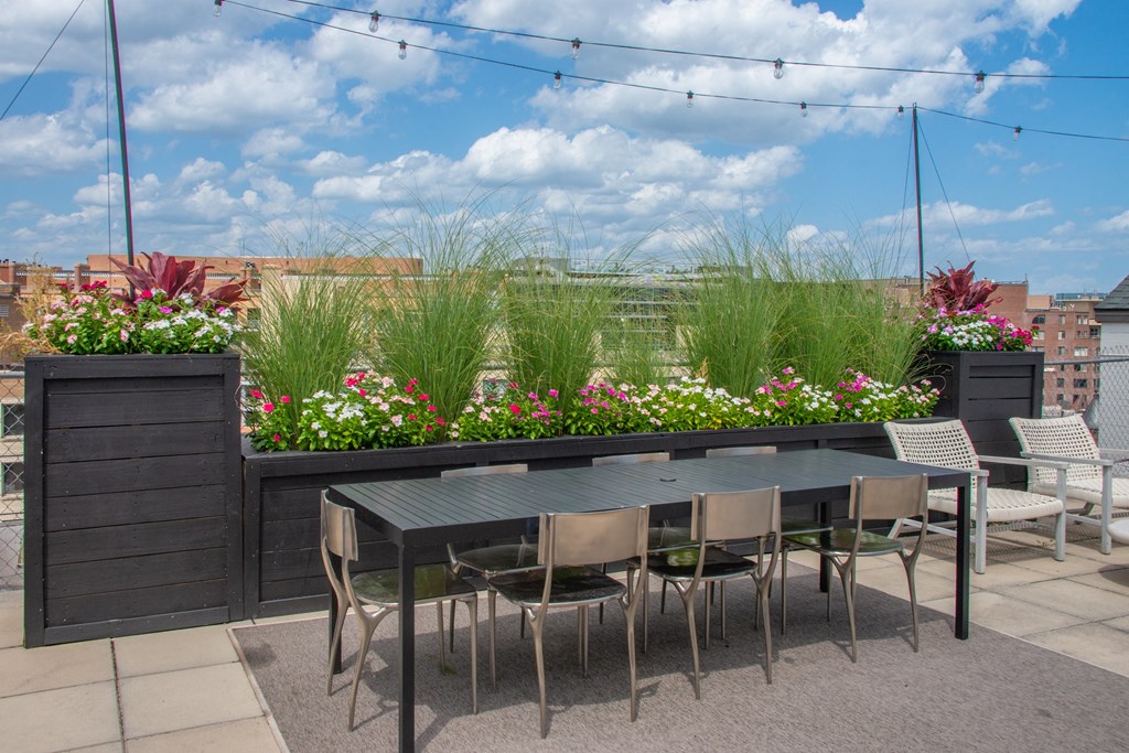a patio with a table and chairs on a roof