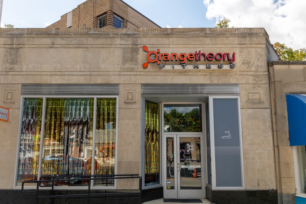 the front of a store with a sign on the side of a building