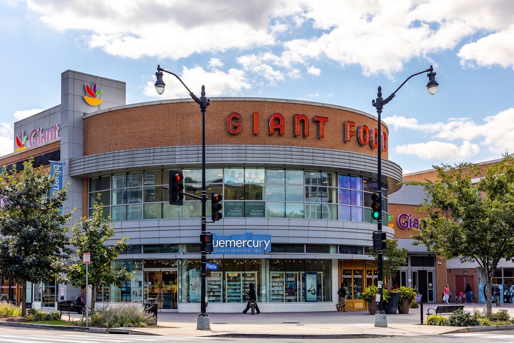 a large building with a giant corn sign on top of it on a city street