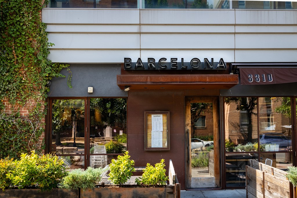 the front of a barcelona restaurant with a sign in the window