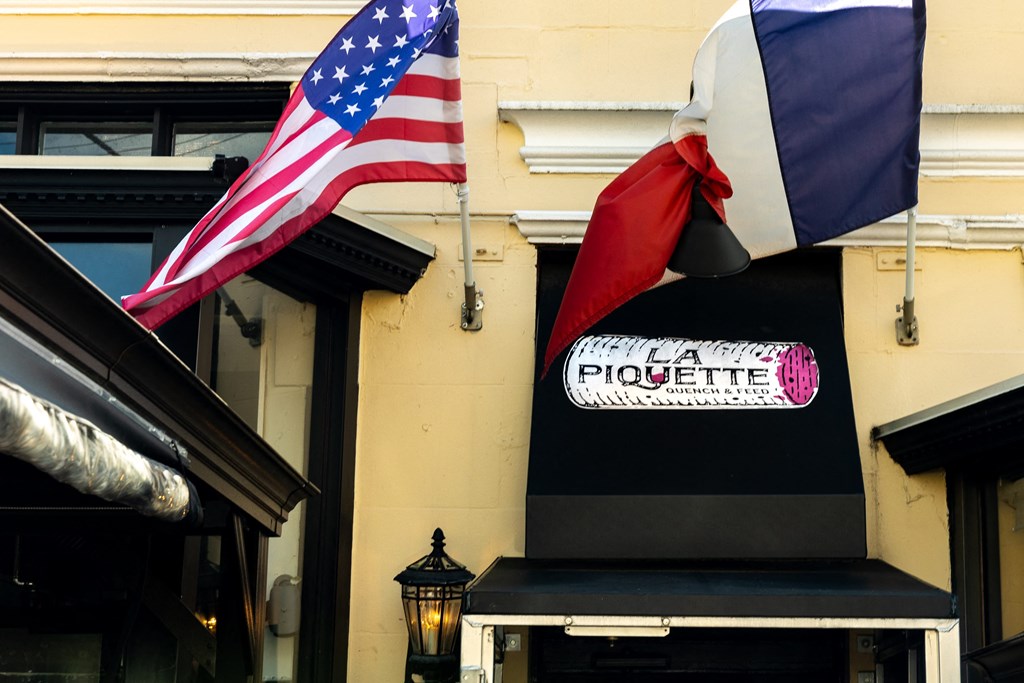 a flag and a sign on the side of a building