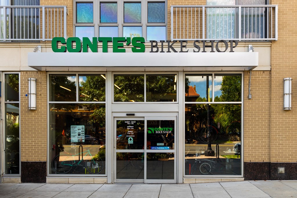 the front of a converse bike shop with a sign above the door