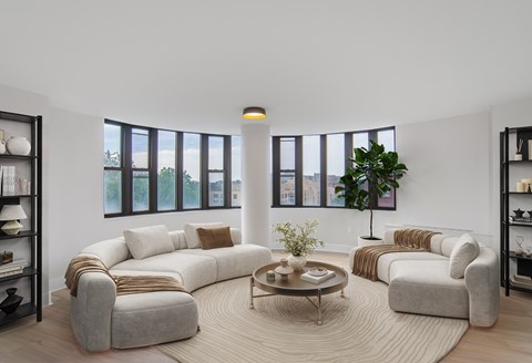 A living room with a large sectional sofa and a coffee table.