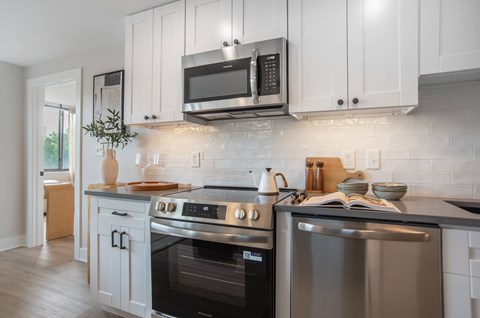 A modern kitchen with a stainless steel oven and microwave.