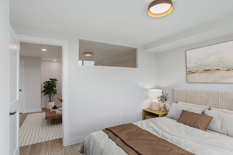 A bedroom with a large bed and a painting on the wall.