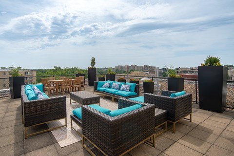 A patio with a table and chairs overlooking a cityscape.