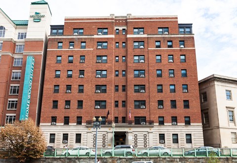 a large brick building with a fountain in front of it