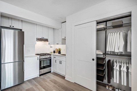 a kitchen with white cabinets and stainless steel appliances