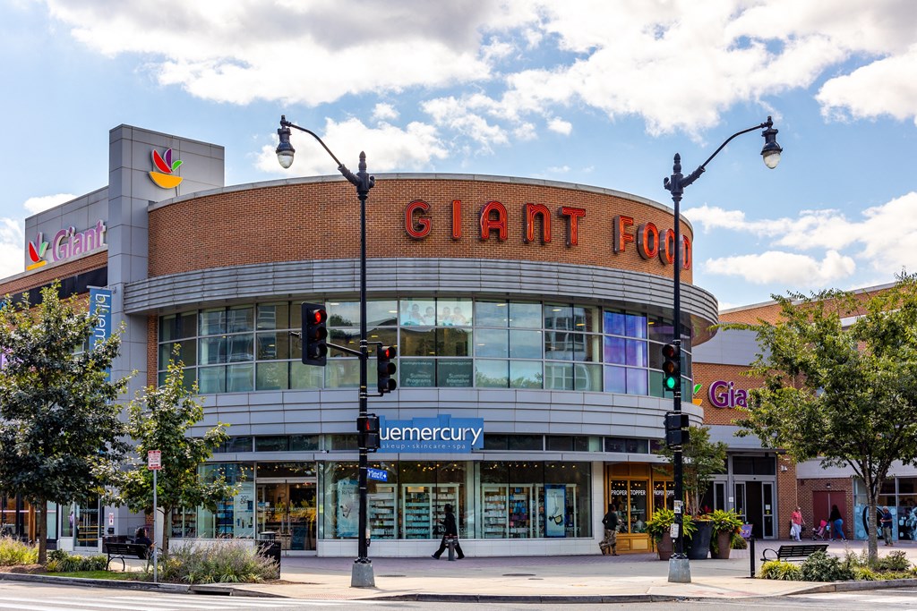 a large building with a giant corn sign on top of it on a city street