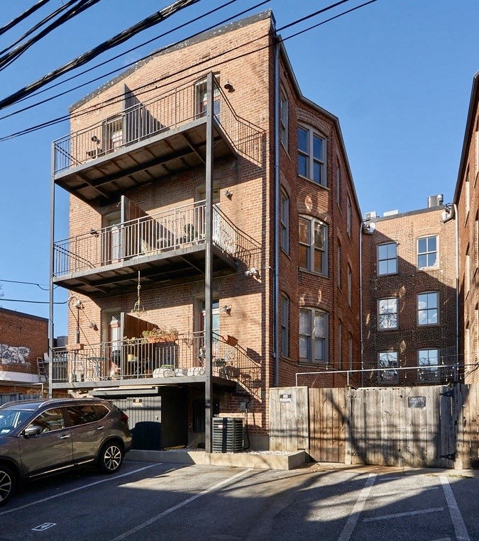 a brick building with a car parked in front of it