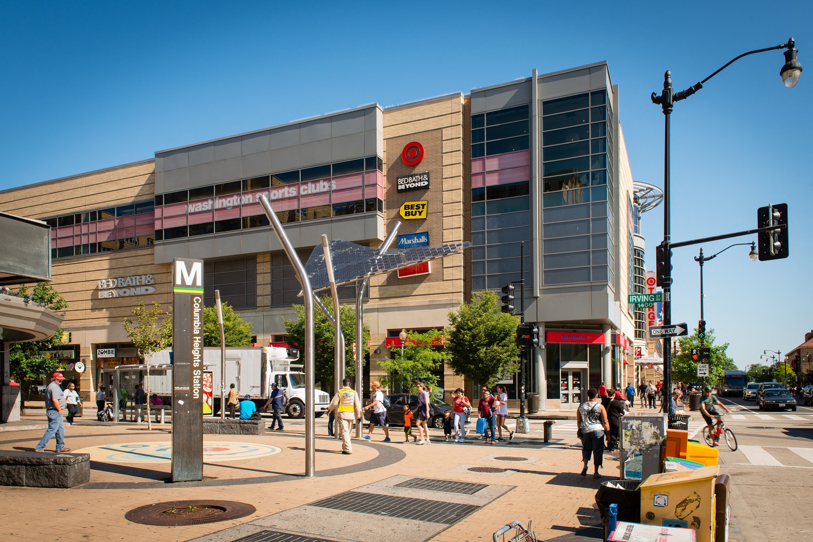 people crossing the street in front of a large building