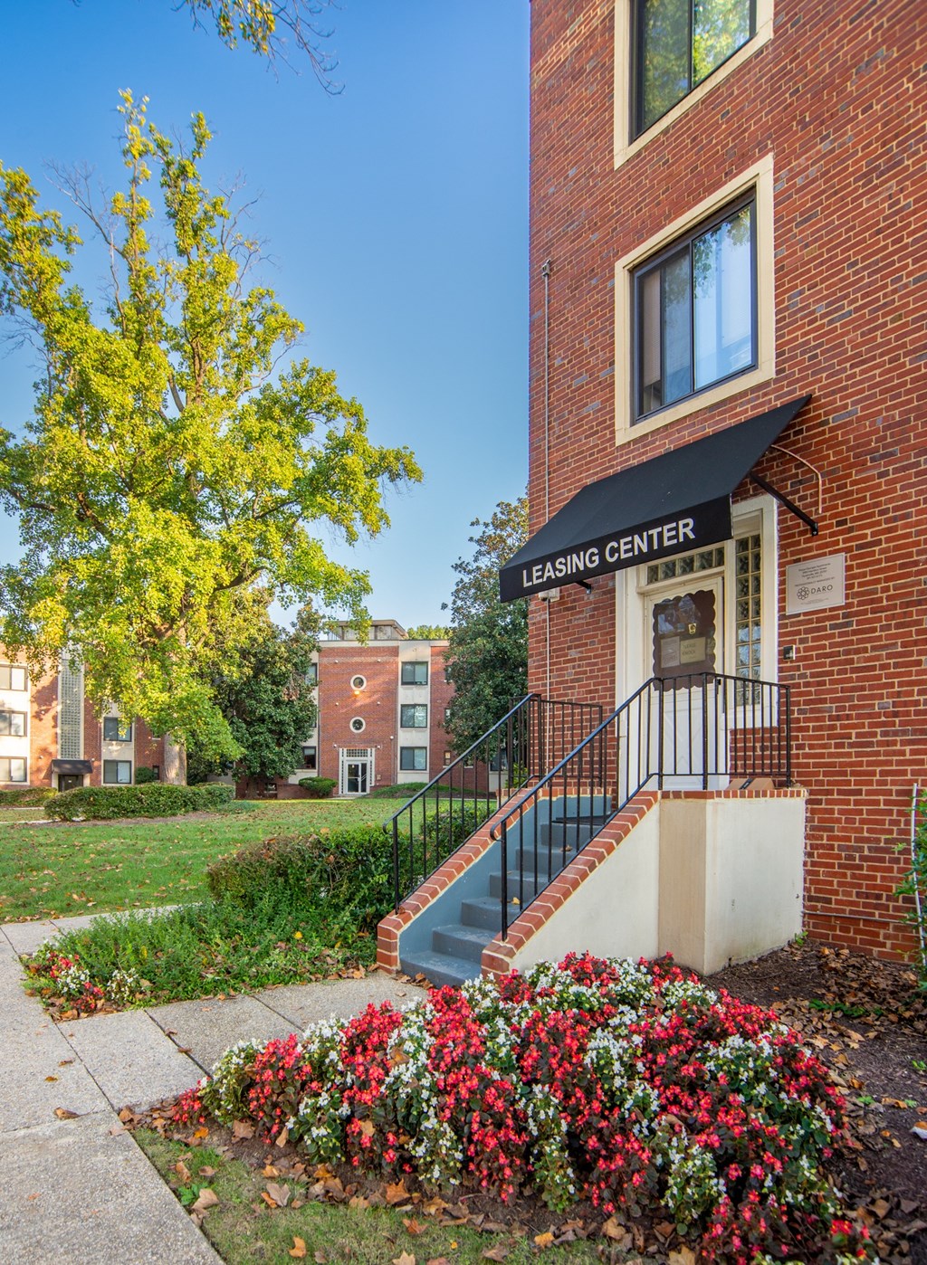 building with stairs and flowers in front of it