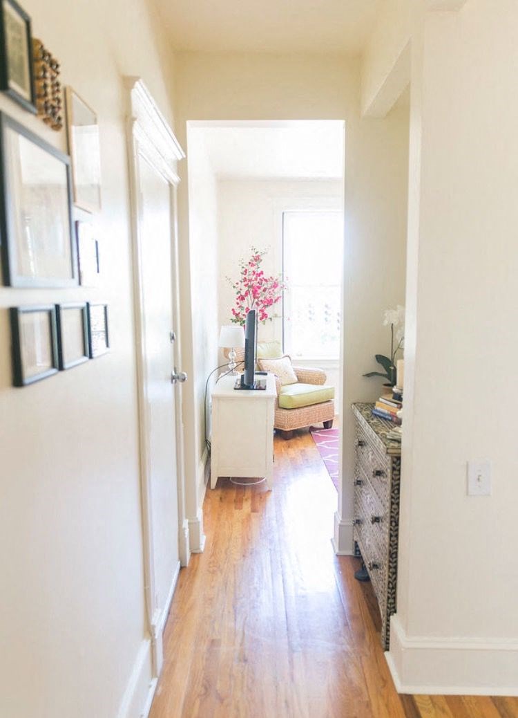 a living room with a hard wood floor and a white door