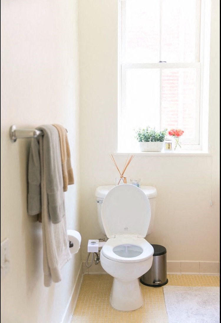 a small bathroom with a toilet and a window