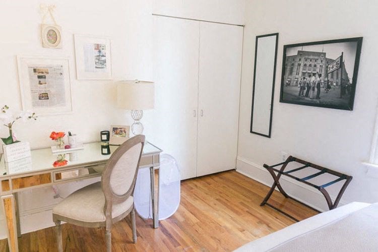 a living room with a desk and a chair