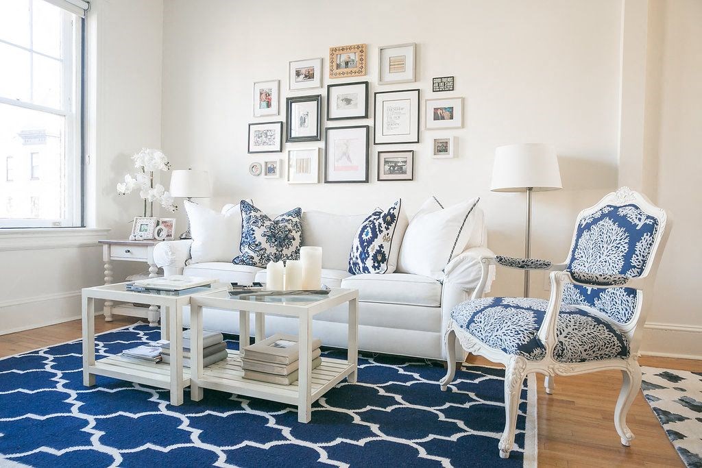 a living room with blue and white furniture and a rug