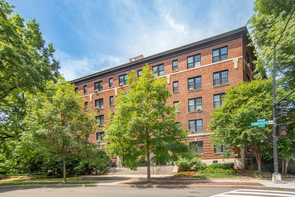 a large red brick building with trees in front of it