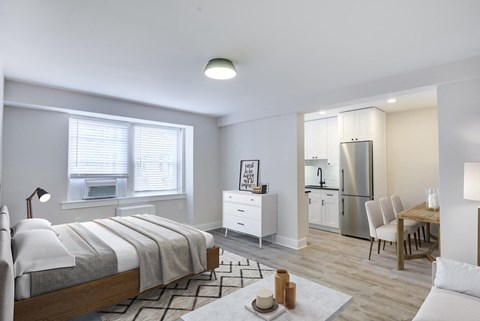 a bedroom with a bed and a refrigerator