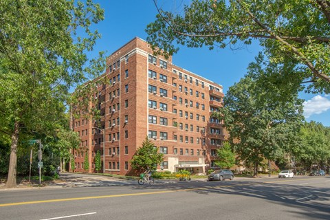 a large brick building on the corner of a city street