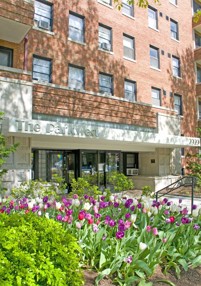 a large brick building with flowers in front of it