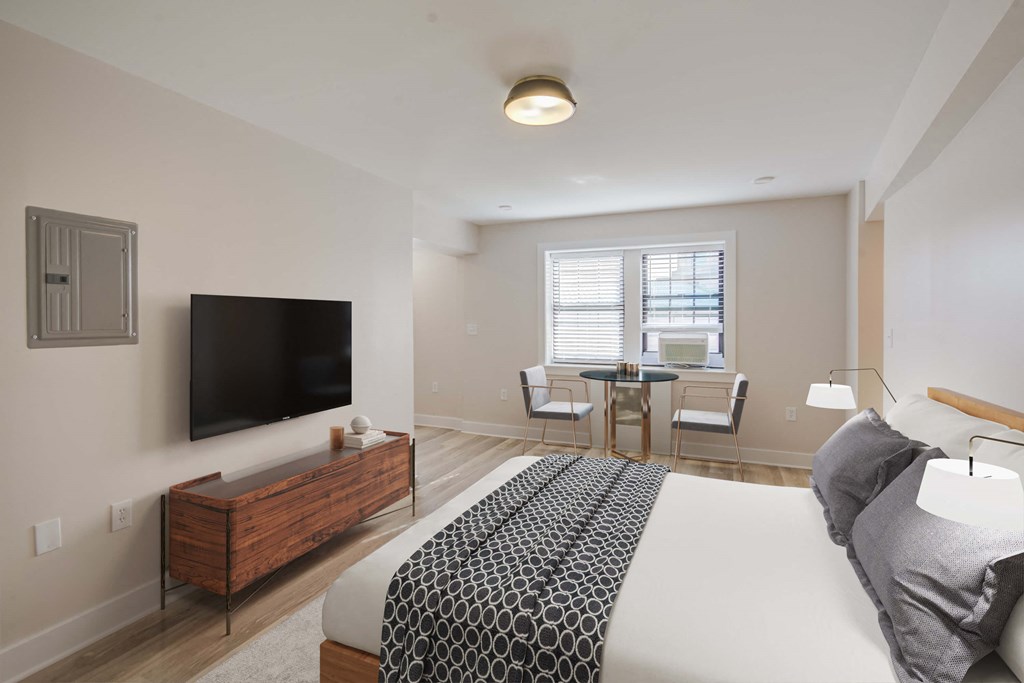 a bedroom with a bed and a television