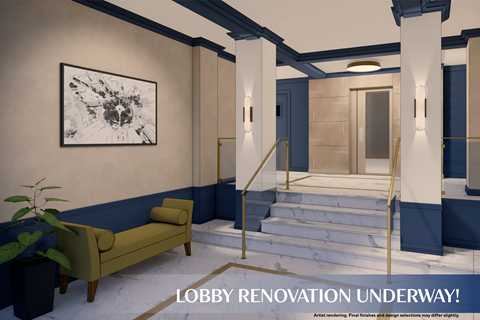 A lobby undergoing renovation with a green sofa and a large painting on the wall.
