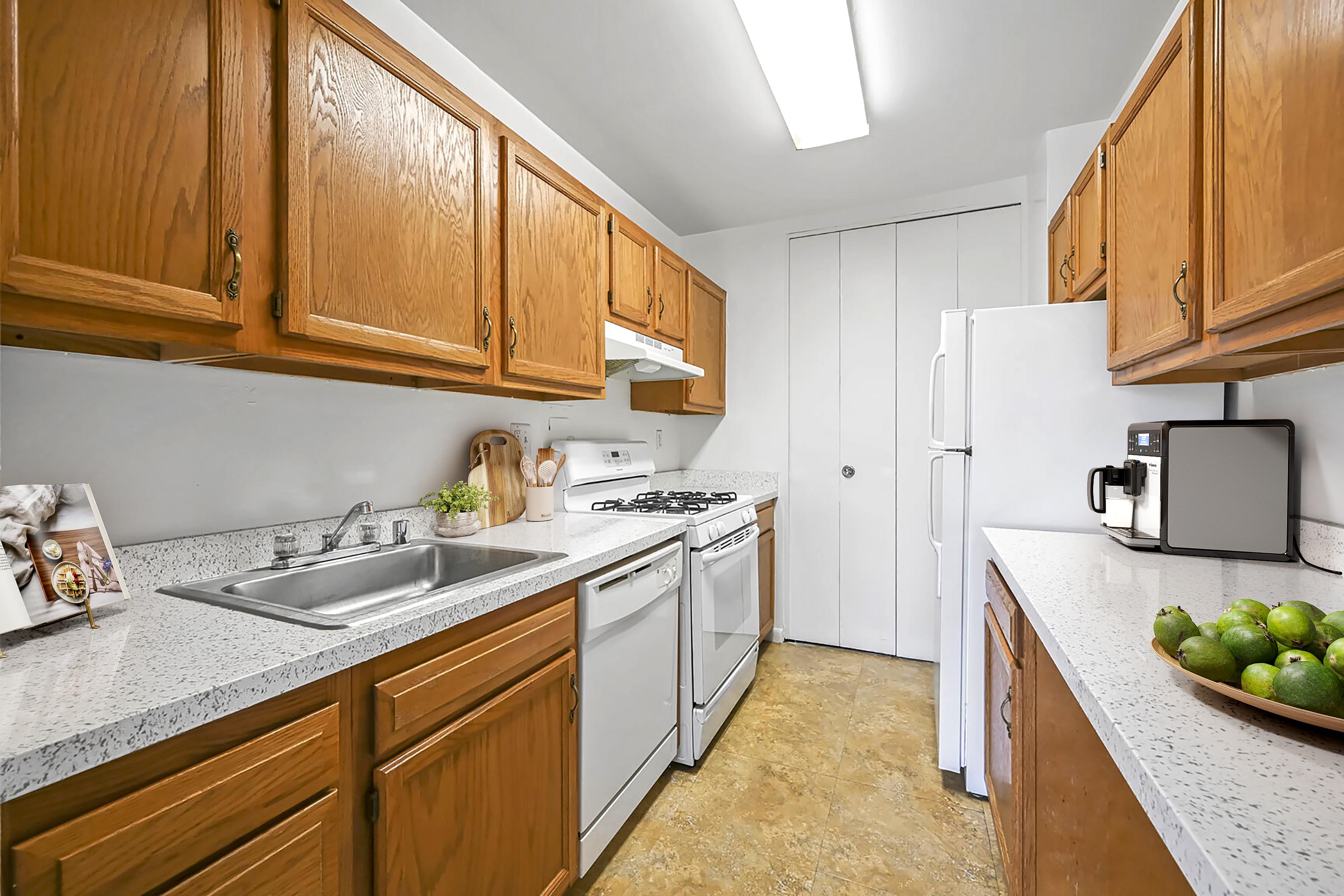 A kitchen with wooden cabinets and a white refrigerator.