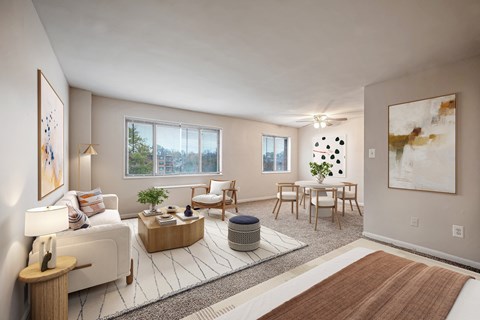 A living room with a white couch, a wooden coffee table, and a large painting on the wall.