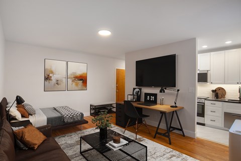 A modern living room with a brown couch and a black coffee table.