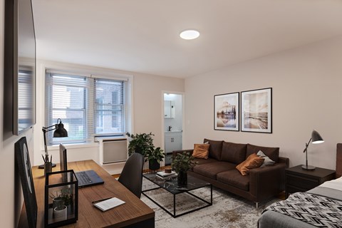 A modern living room with a brown couch and a black coffee table.