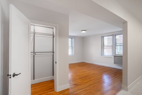 A room with wooden floors and white walls.