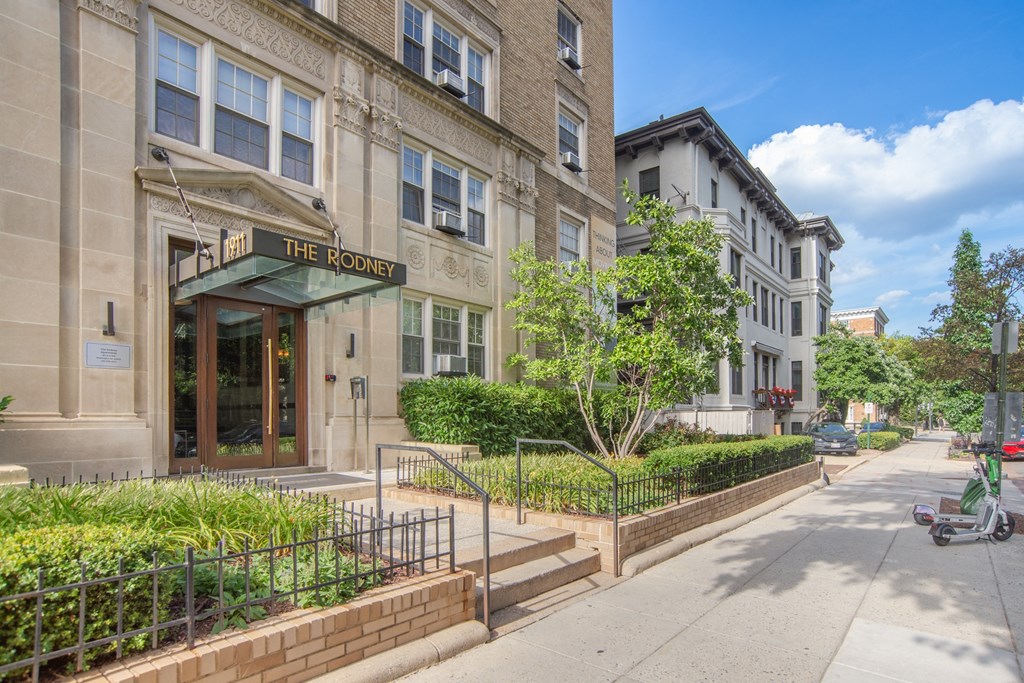 the front of a building on a city street with a moped