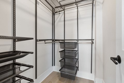 a laundry room with black racks and a white wall