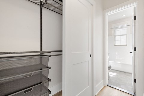 a laundry room with white walls and a white door