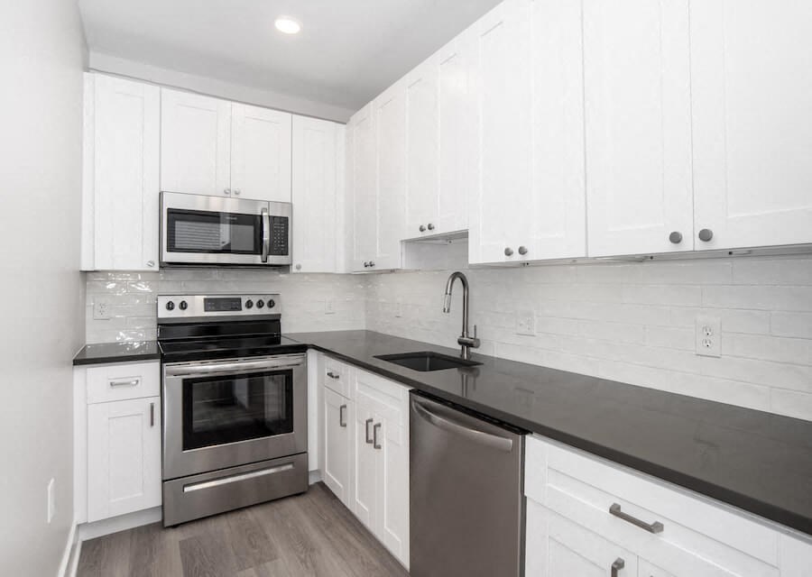 white kitchen with stainless steel appliances and white cabinets