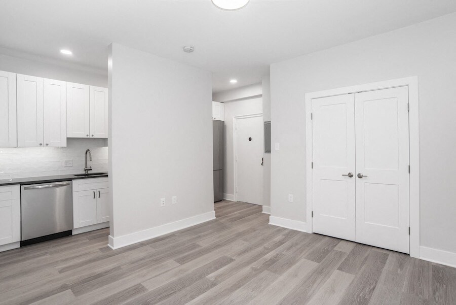 renovated kitchen with white cabinets and stainless steel appliances
