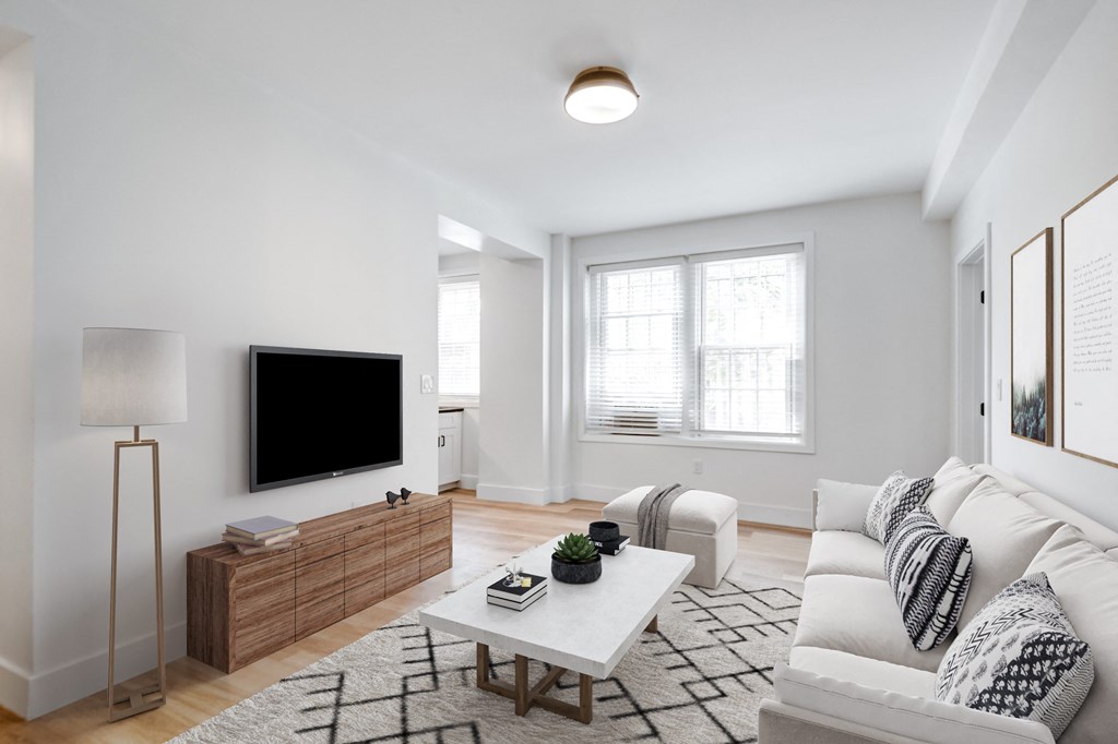 a living room with a white couch and a coffee table