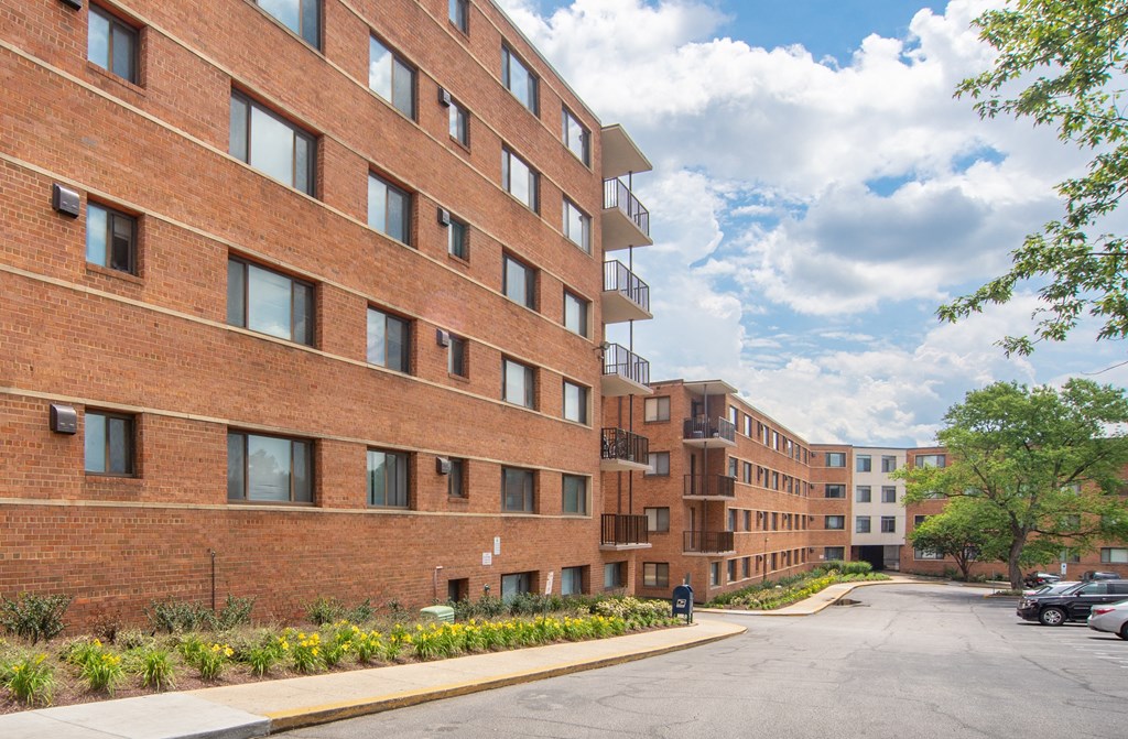 a large brick building with a street in front of it