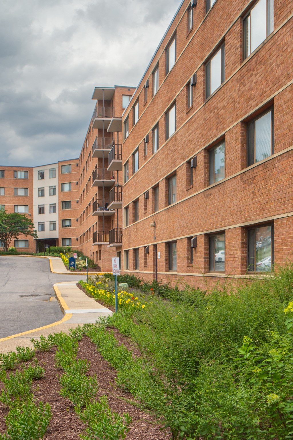 a large brick building with a street in front of it