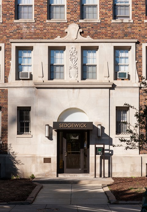 the facade of a building with a door and a sign in front of it