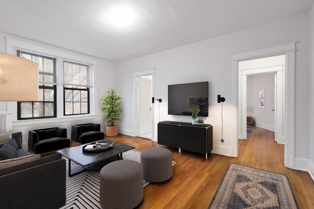 a living room with black furniture and a tv