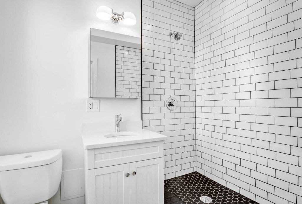 a white bathroom with a sink and a toilet