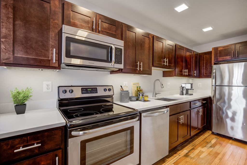 a kitchen with stainless steel appliances and wooden cabinets